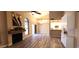 Inviting living room featuring wood-look floors, a fireplace, and a view into a brightly lit kitchen at 5640 E Bell Rd # 1047, Scottsdale, AZ 85254