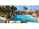 Beautiful community pool and seating area surrounded by lush palm trees and greenery, offering a tranquil retreat at 5640 E Bell Rd # 1047, Scottsdale, AZ 85254