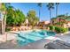 Community swimming pool surrounded by palm trees, greenery, and lounge chairs, offering a resort-like atmosphere at 5640 E Bell Rd # 1047, Scottsdale, AZ 85254