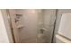 Modern glass-enclosed shower featuring tiled walls, built-in shelving, and hexagon tiled floors at 5640 E Bell Rd # 1047, Scottsdale, AZ 85254