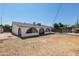 Exterior view of home with a large backyard and arched porch leading to a pool area at 5802 N 61St Dr, Glendale, AZ 85301