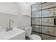 Bathroom with tiled glass door shower, toilet and sink with modern fixtures at 5802 N 61St Dr, Glendale, AZ 85301