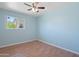 Bedroom with light blue walls, ceiling fan, and natural light at 5802 N 61St Dr, Glendale, AZ 85301