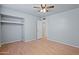 Bedroom with a built-in closet, light gray walls, and ceiling fan at 5802 N 61St Dr, Glendale, AZ 85301