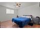 Bedroom with a blue bedspread and natural light from the window at 5802 N 61St Dr, Glendale, AZ 85301