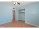 Bedroom with light blue walls, ceiling fan, and closet view at 5802 N 61St Dr, Glendale, AZ 85301