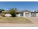 Charming single-story home featuring a well-maintained front yard, driveway, and attached garage at 5802 N 61St Dr, Glendale, AZ 85301