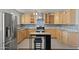 Well-equipped kitchen featuring stainless steel appliances, granite countertops, and a center island with stools at 5802 N 61St Dr, Glendale, AZ 85301