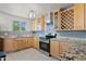 Well-designed kitchen featuring modern appliances, granite counters, wood cabinets, and tile flooring at 5802 N 61St Dr, Glendale, AZ 85301