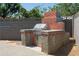 Outdoor grill with brick surround and gray block privacy wall at 5802 N 61St Dr, Glendale, AZ 85301