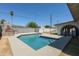 A private backyard pool with a built-in BBQ, set against a clear blue sky at 5802 N 61St Dr, Glendale, AZ 85301