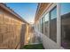 Side yard featuring pet-friendly artificial turf and protective fence at 5897 N 195Th Dr, Litchfield Park, AZ 85340