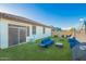 Wide shot of artificial lawn with outdoor seating and string lights at 5897 N 195Th Dr, Litchfield Park, AZ 85340