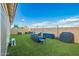 Backyard with well-manicured artificial lawn and outdoor seating area at 5897 N 195Th Dr, Litchfield Park, AZ 85340