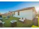Spacious backyard with outdoor furniture, artificial grass, and a clear blue sky at 5897 N 195Th Dr, Litchfield Park, AZ 85340