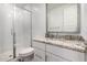 This bathroom features a glass enclosed shower, granite countertop, and neutral decor at 5897 N 195Th Dr, Litchfield Park, AZ 85340