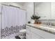 Bathroom featuring granite counters, white cabinets, and a shower with a decorative curtain, combining style and function at 5897 N 195Th Dr, Litchfield Park, AZ 85340