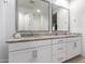 Bathroom boasts a double sink vanity, granite countertop, and modern fixtures at 5897 N 195Th Dr, Litchfield Park, AZ 85340