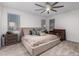 Bright bedroom features a large bed, neutral tones, and a ceiling fan at 5897 N 195Th Dr, Litchfield Park, AZ 85340