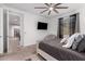 This bedroom features a ceiling fan, a wall mounted television and neutral decor at 5897 N 195Th Dr, Litchfield Park, AZ 85340
