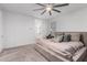 Bright bedroom with neutral tones, a ceiling fan, and access to the ensuite bath at 5897 N 195Th Dr, Litchfield Park, AZ 85340
