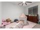 Bright bedroom featuring playful decor, a cozy play tent, and ample storage with a classic dresser at 5897 N 195Th Dr, Litchfield Park, AZ 85340