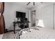 Well-lit bedroom with a desk, tv, and gaming console at 5897 N 195Th Dr, Litchfield Park, AZ 85340