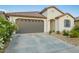 Charming single-Gathering home featuring a tile roof, desert landscaping, and attached two-car garage at 5897 N 195Th Dr, Litchfield Park, AZ 85340
