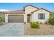Inviting home with well-kept yard, desert landscaping, and covered entryway at 5897 N 195Th Dr, Litchfield Park, AZ 85340