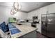 Bright kitchen features granite countertops, stainless appliances, and elegant lighting at 5897 N 195Th Dr, Litchfield Park, AZ 85340