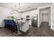 Modern kitchen with stainless steel appliances, pendant lights, and a kitchen island with seating at 5897 N 195Th Dr, Litchfield Park, AZ 85340