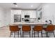 Modern kitchen with granite countertops, stainless steel appliances, and a convenient breakfast bar with seating at 5897 N 195Th Dr, Litchfield Park, AZ 85340