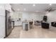 Open floor plan boasts living room and kitchen with neutral tile flooring and recessed lighting at 5897 N 195Th Dr, Litchfield Park, AZ 85340