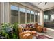Stylish sunroom featuring tile floors, ceiling fan, and walls of windows at 5897 N 195Th Dr, Litchfield Park, AZ 85340