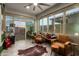 Bright sunroom featuring tile floors, ceiling fan, and lots of windows at 5897 N 195Th Dr, Litchfield Park, AZ 85340