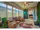 Bright sunroom with multiple seating areas, a view of the backyard, and unique decor at 5897 N 195Th Dr, Litchfield Park, AZ 85340