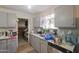 Kitchen featuring neutral gray cabinets and a stainless steel dishwasher at 6101 N 31St Dr, Phoenix, AZ 85017