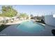 This backyard oasis features a pool surrounded by a concrete pool deck and well-manicured landscaping at 6101 N 31St Dr, Phoenix, AZ 85017