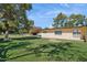 Large backyard with lush green grass and shade trees creating a serene outdoor space at 6147 E Lewis Ave, Scottsdale, AZ 85257