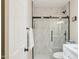 Bathroom with glass shower enclosure, white tile surround, and modern hardware at 6147 E Lewis Ave, Scottsdale, AZ 85257