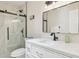 Modern bathroom features white countertop, black fixtures, and glass enclosed shower at 6147 E Lewis Ave, Scottsdale, AZ 85257
