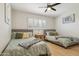 Bedroom showcasing two beds, neutral walls, and wood floors at 6147 E Lewis Ave, Scottsdale, AZ 85257
