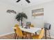Dining room with a white table and wood floors and mid-century modern yellow chairs at 6147 E Lewis Ave, Scottsdale, AZ 85257