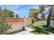 Home exterior featuring a gated entrance, arched gate, stucco wall, tile roof, and desert landscaping at 6147 E Lewis Ave, Scottsdale, AZ 85257