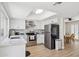 Bright kitchen with stainless steel appliances, white cabinets, and a skylight above a white quartz island at 6147 E Lewis Ave, Scottsdale, AZ 85257