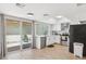 Light and bright kitchen with stainless appliances, quartz countertops, and a sliding door to outside patio at 6147 E Lewis Ave, Scottsdale, AZ 85257