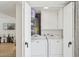 Laundry room featuring a washer and dryer, plus cabinets and shelving for organization at 6147 E Lewis Ave, Scottsdale, AZ 85257