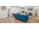 Bright living room features a fireplace, wood floors, plantation shutters and a blue velvet sofa at 6147 E Lewis Ave, Scottsdale, AZ 85257