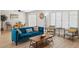 Open-concept living area features wood floors, a ceiling fan, plantation shutters, and a wood coffee table at 6147 E Lewis Ave, Scottsdale, AZ 85257