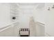 Organized walk-in closet featuring white shelves and ample storage space for clothes and accessories at 6147 E Lewis Ave, Scottsdale, AZ 85257